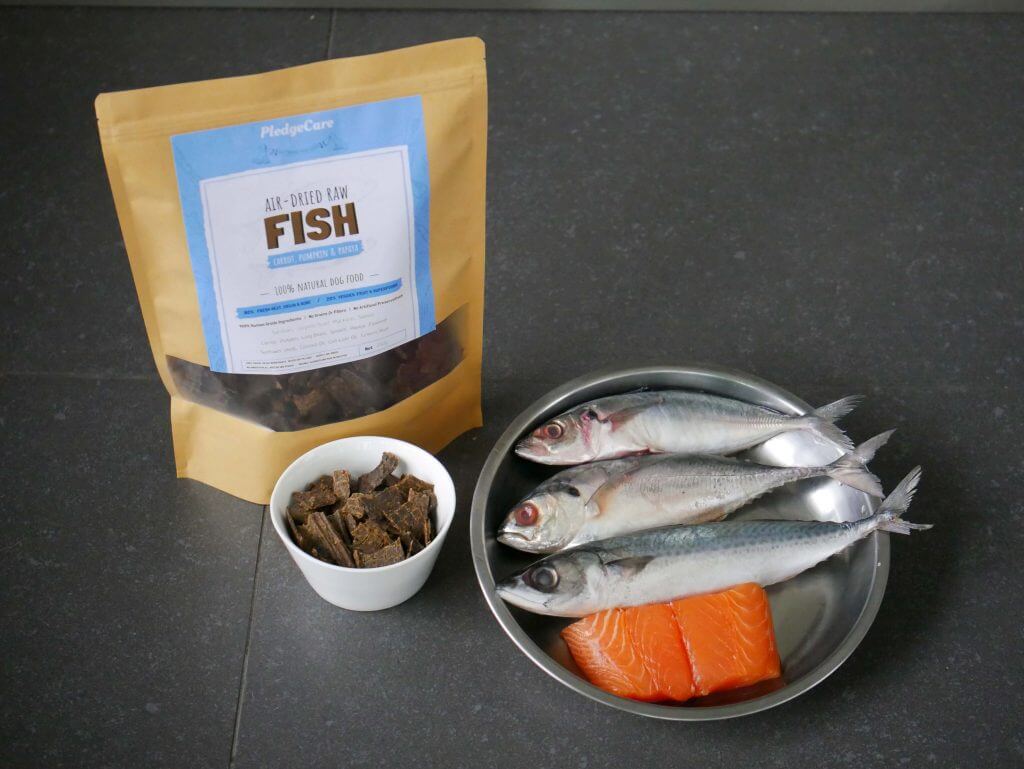 a 750g of pledgecare air dried recipe on display along with a plate of fresh fishes 